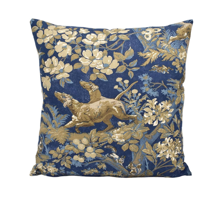 a decorative pillow with a floral pattern in shades of blue and gold.