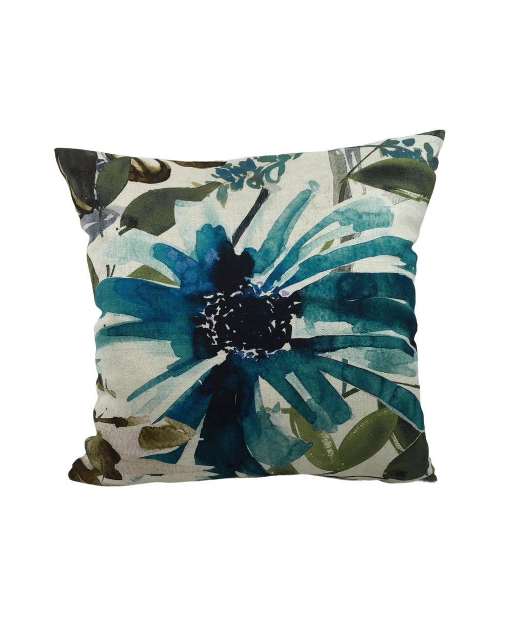 a pillow with a blue flower on it