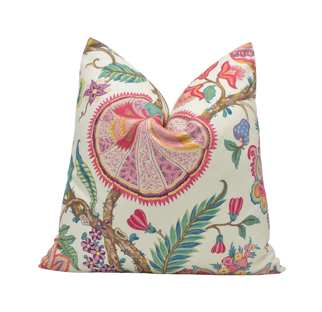 a white pillow with a colorful floral design on it