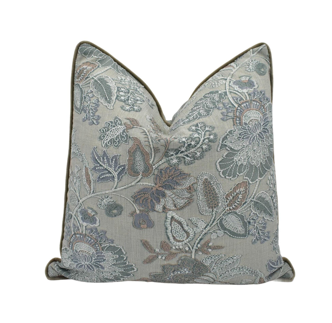 a blue and white pillow with a floral pattern