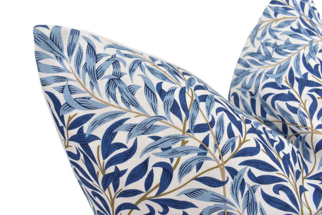 a close up of a blue and white pillow on a white background