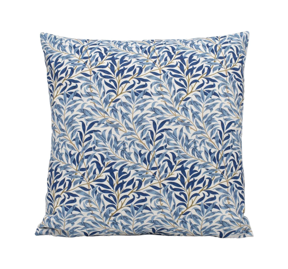 a blue and white pillow with leaves on it