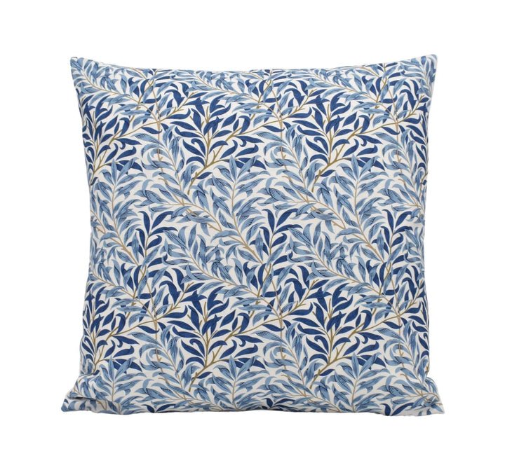 a blue and white pillow with leaves on it