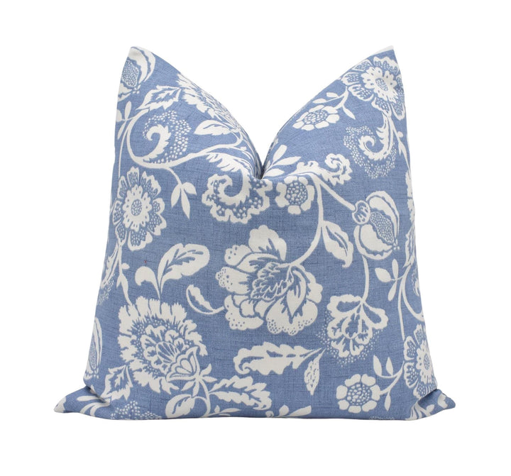 a blue pillow with white flowers on it