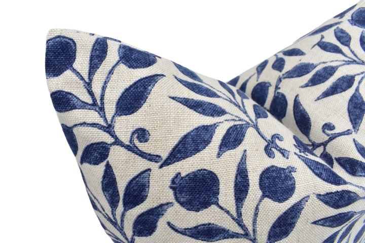 a close up of a blue and white pillow on a white background
