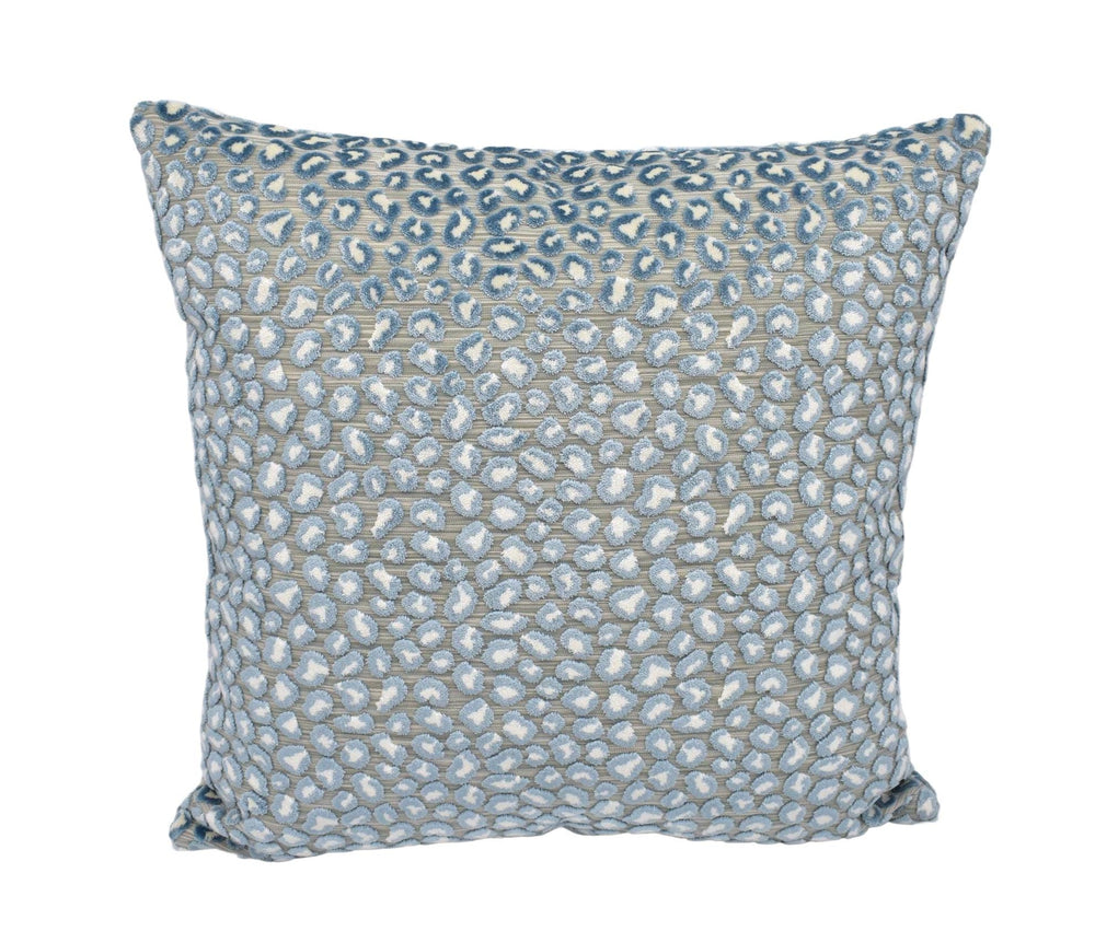 a blue and white pillow on a white background