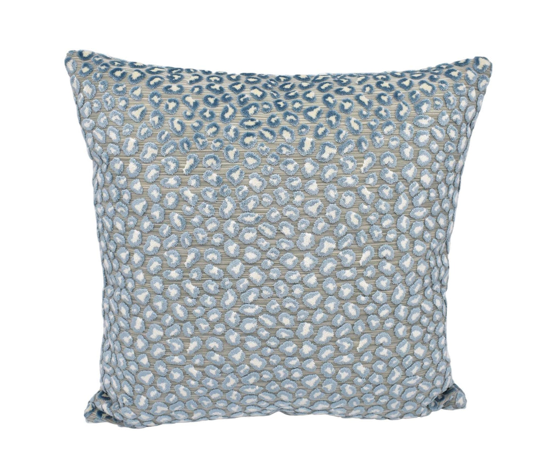 a blue and white pillow on a white background