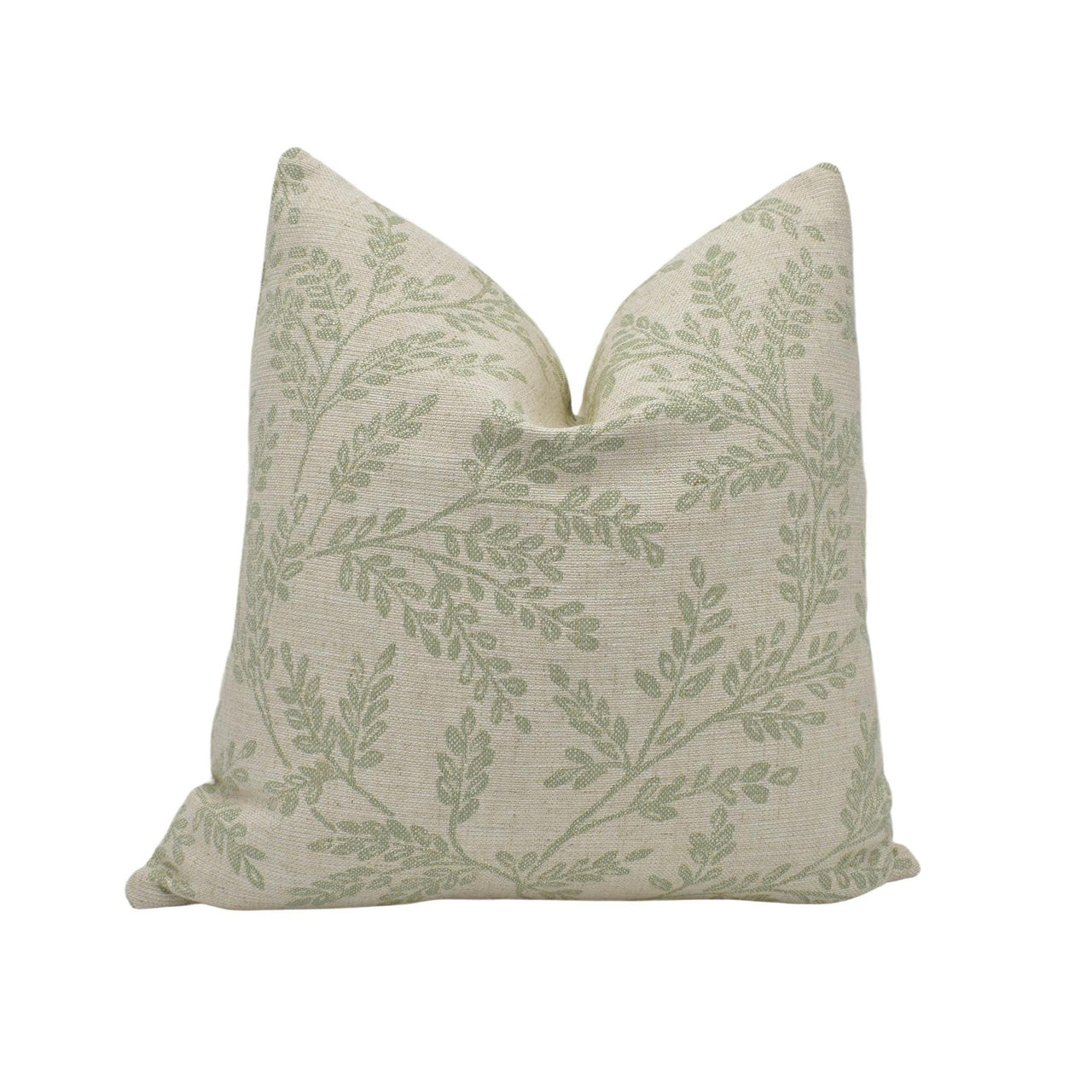 a green and white pillow on a white background