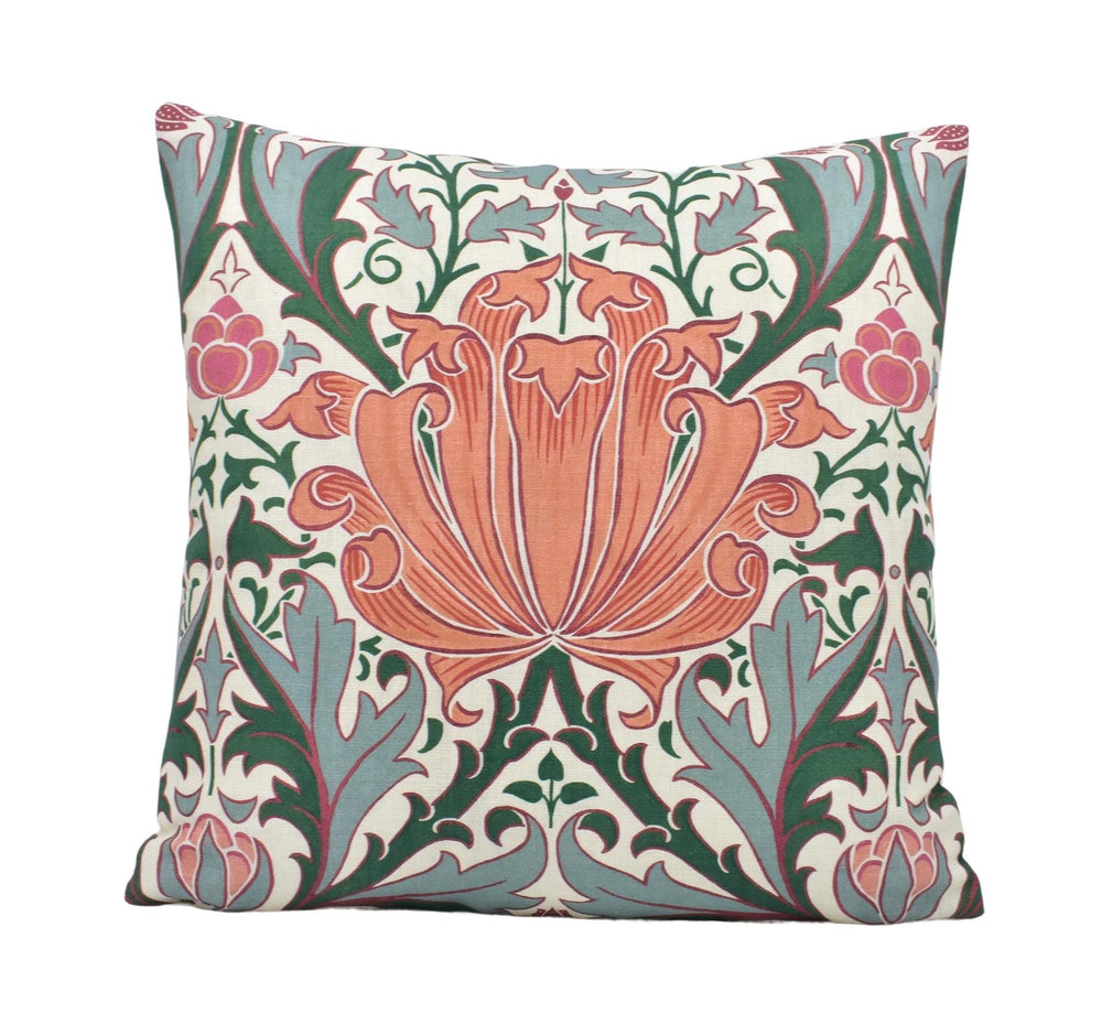 a decorative pillow with an orange flower on a white background
