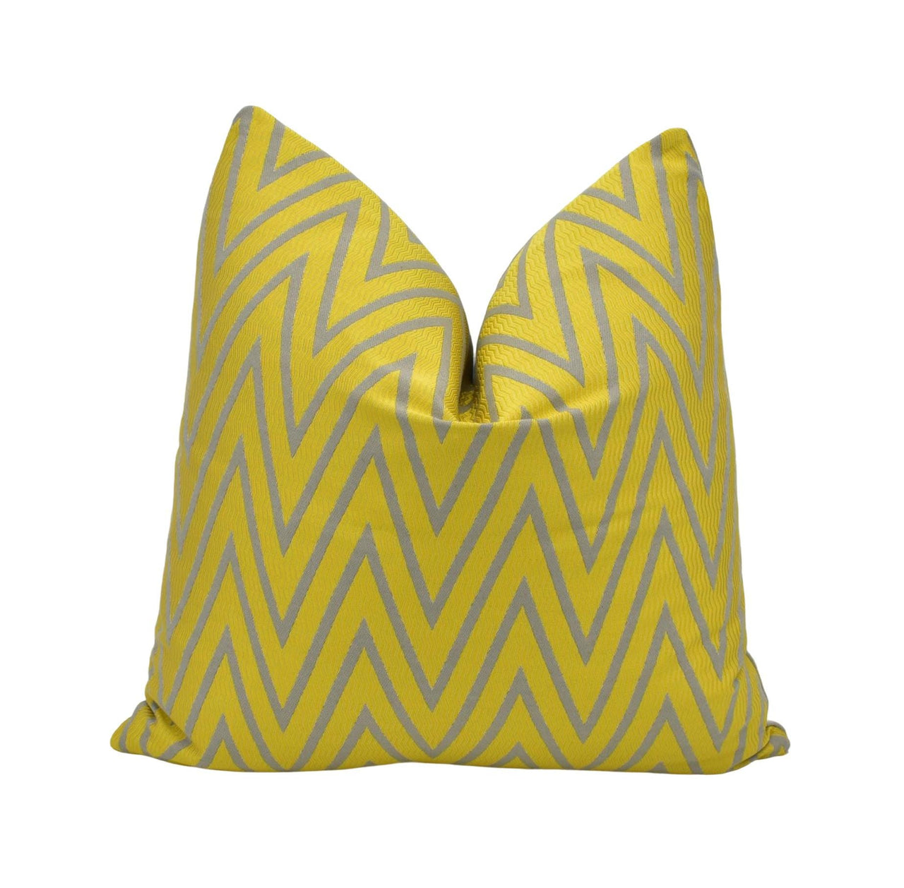 a yellow and grey pillow on a white background