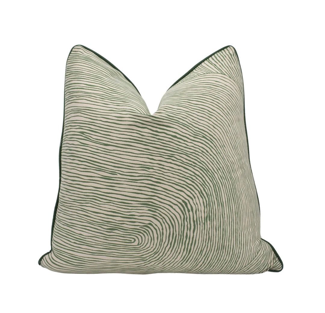a green and white pillow on a white background