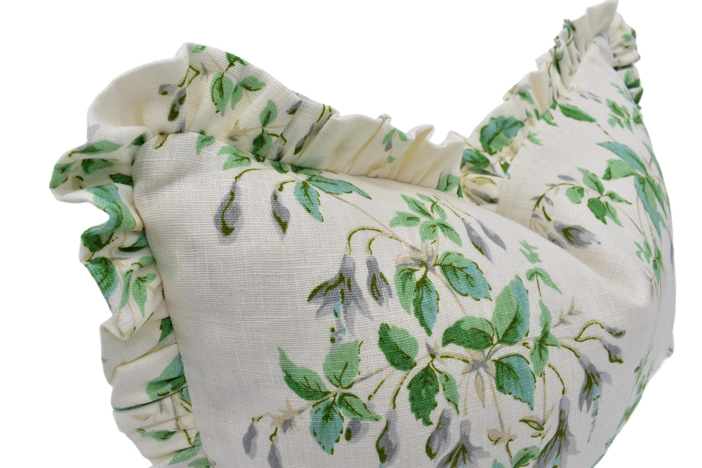 a close up of a green and white pillow on a white background