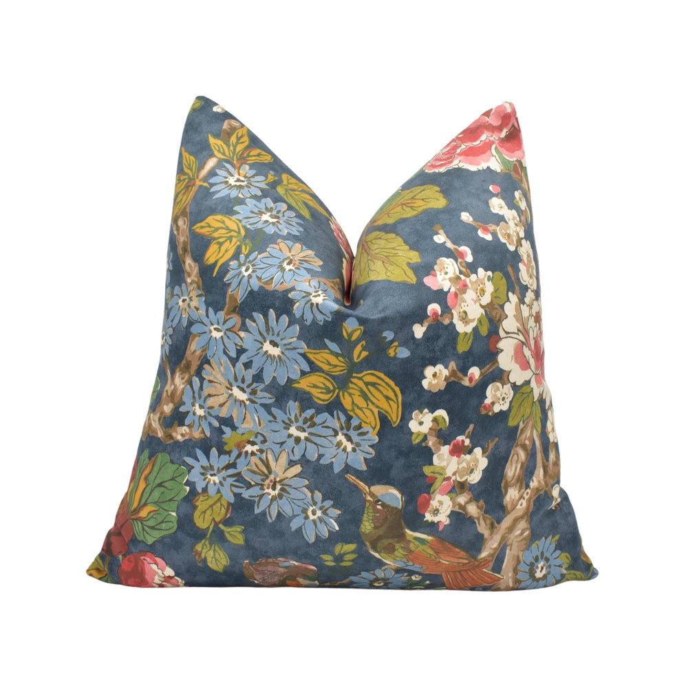 a blue floral pillow on a white background