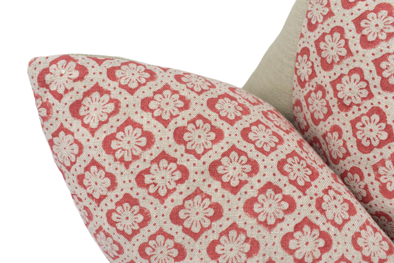 a close up of a red and white pillow