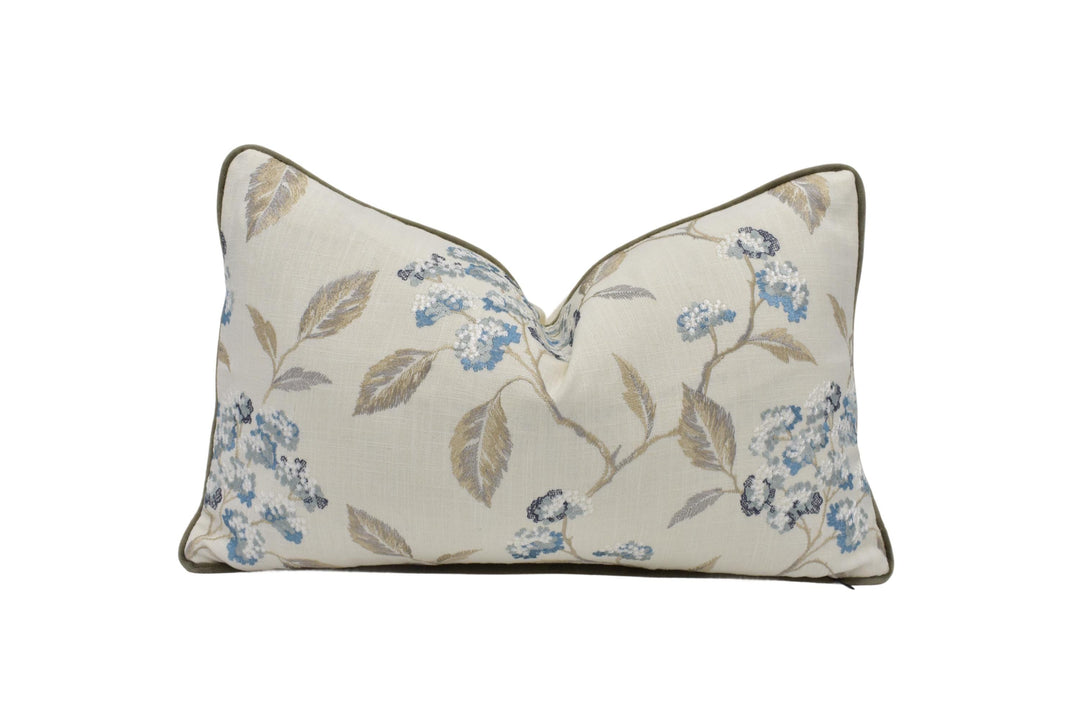 a white pillow with blue flowers on it