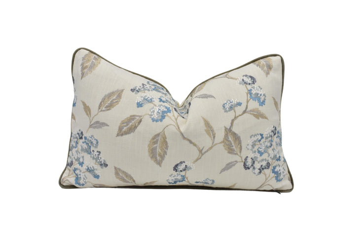 a white pillow with blue flowers on it