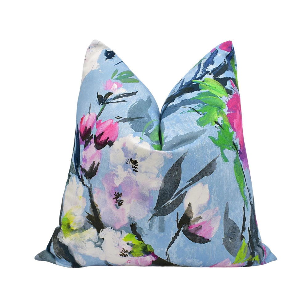 a blue floral pillow with pink and green flowers