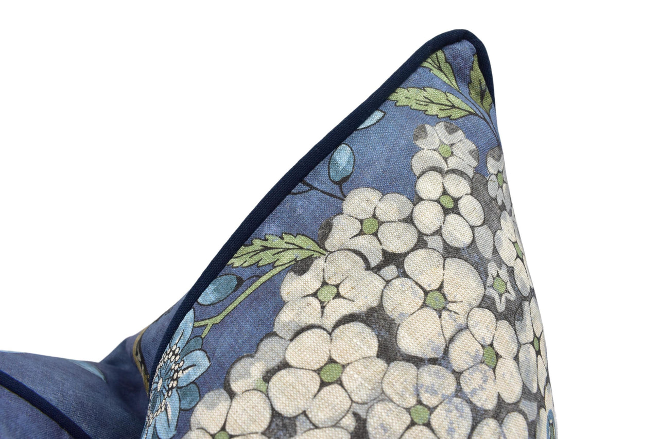 a blue pillow with a bunch of white flowers on it