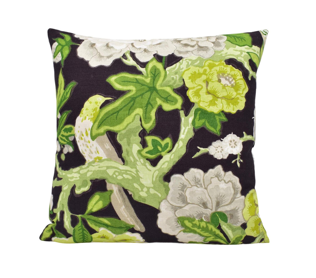 a green and white pillow with flowers on it