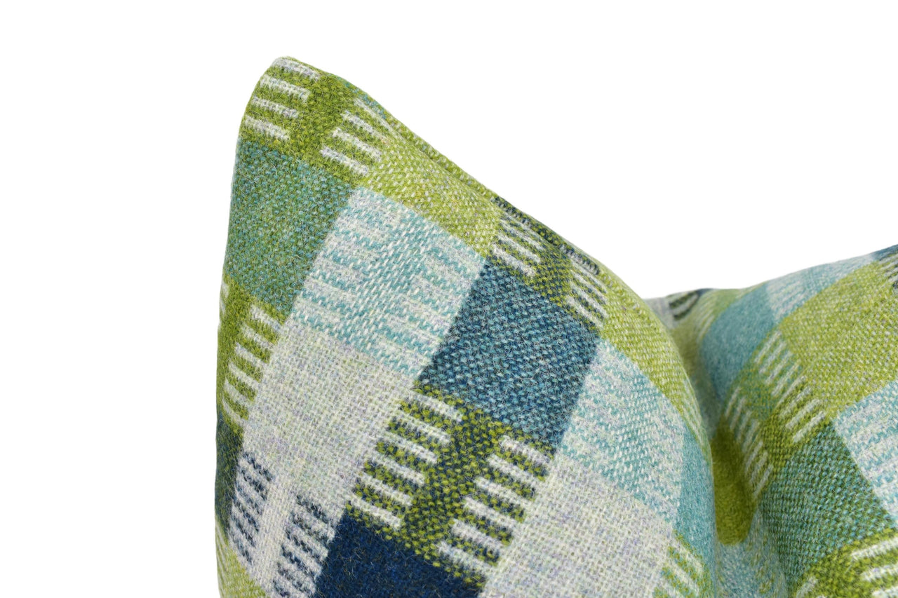 a close up of a green and blue pillow