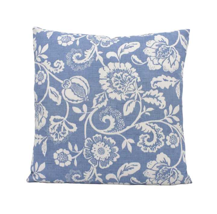 a blue pillow with white flowers on it