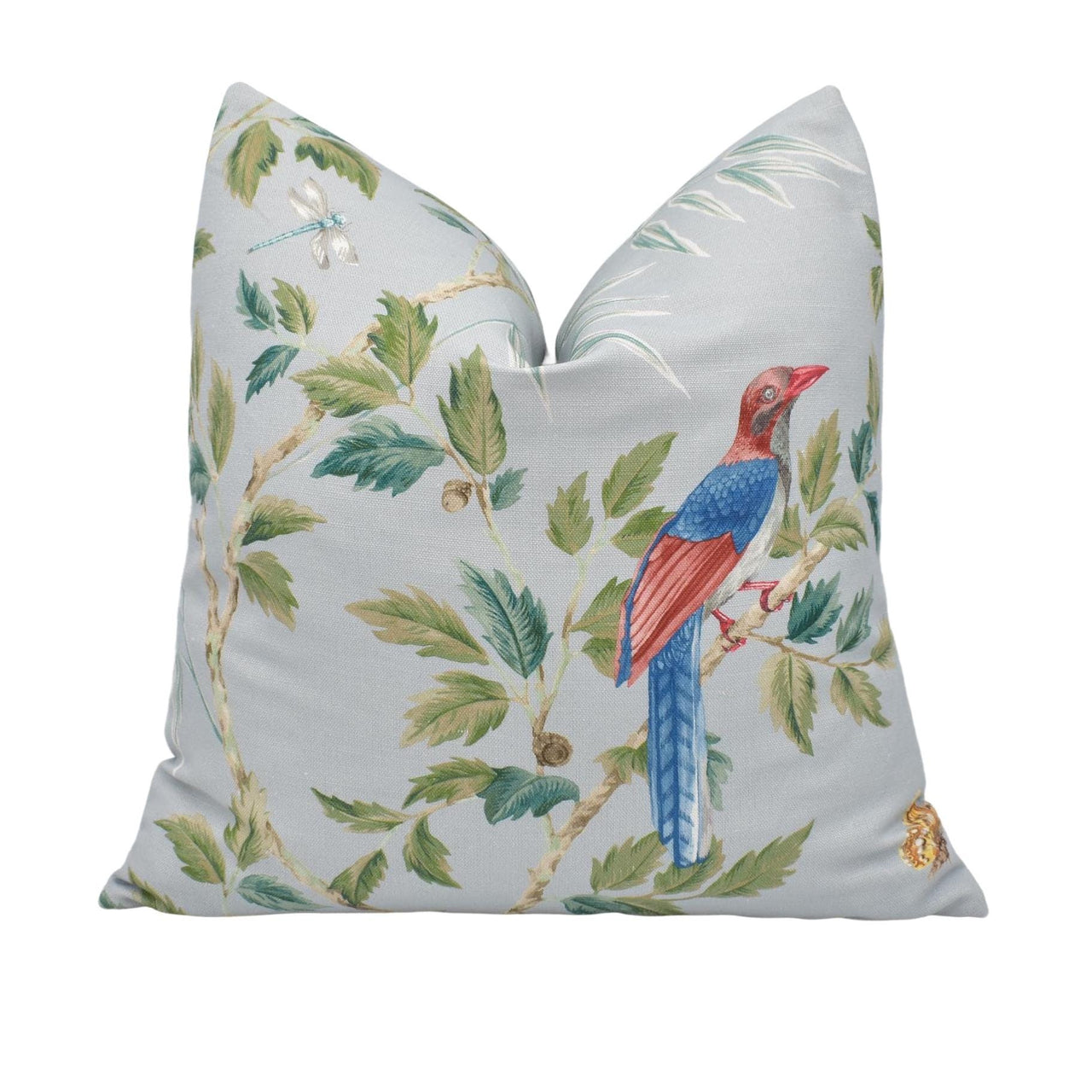 a white pillow with a blue and red bird on it