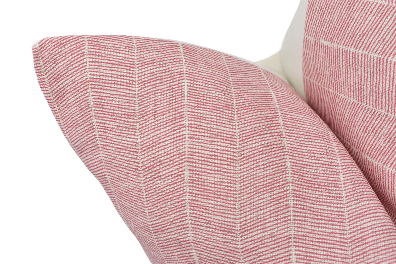 a close up of a pink and white pillow