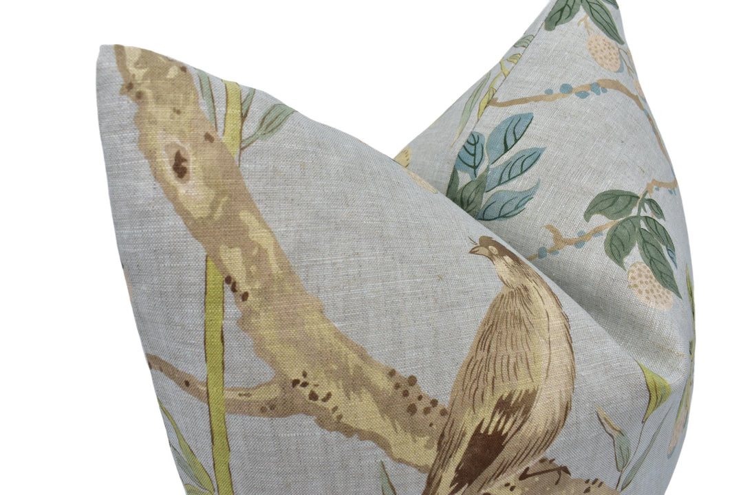 a close up of a pillow with a bird on it