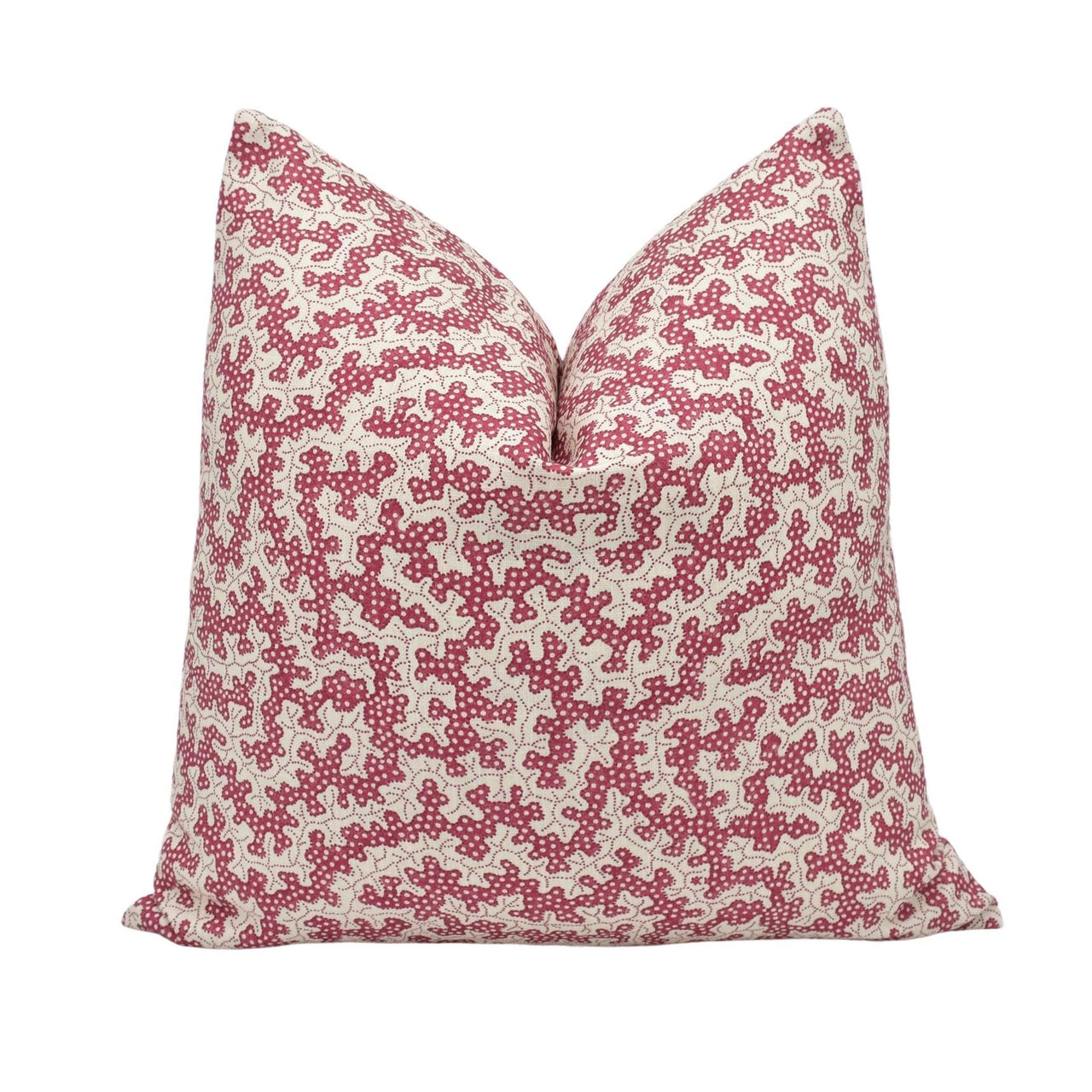 a red and white pillow on a white background