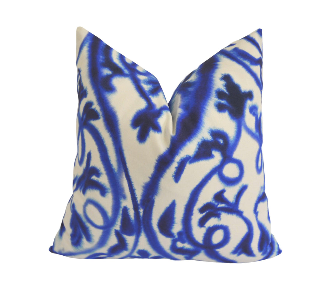 a blue and white pillow on a white background