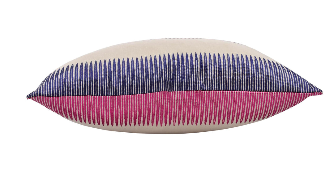 A pillow with a striped pattern in shades of pink and blue.