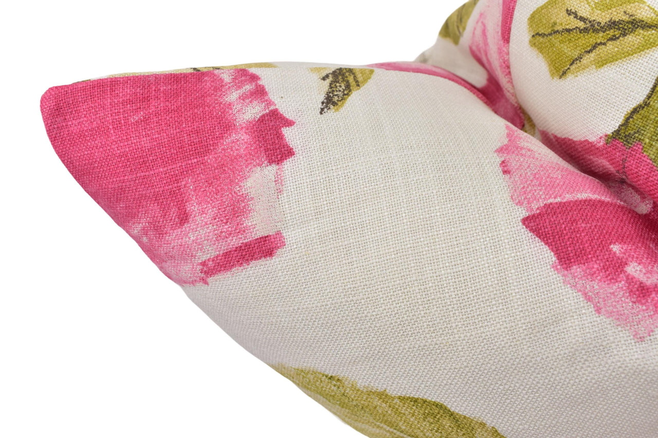 a close up of a pink and yellow pillow on a white background