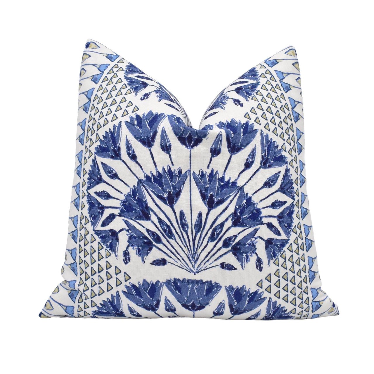 a blue and white pillow on a white background