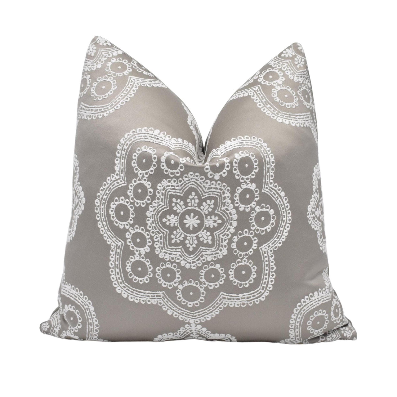 a gray and white pillow with a decorative design