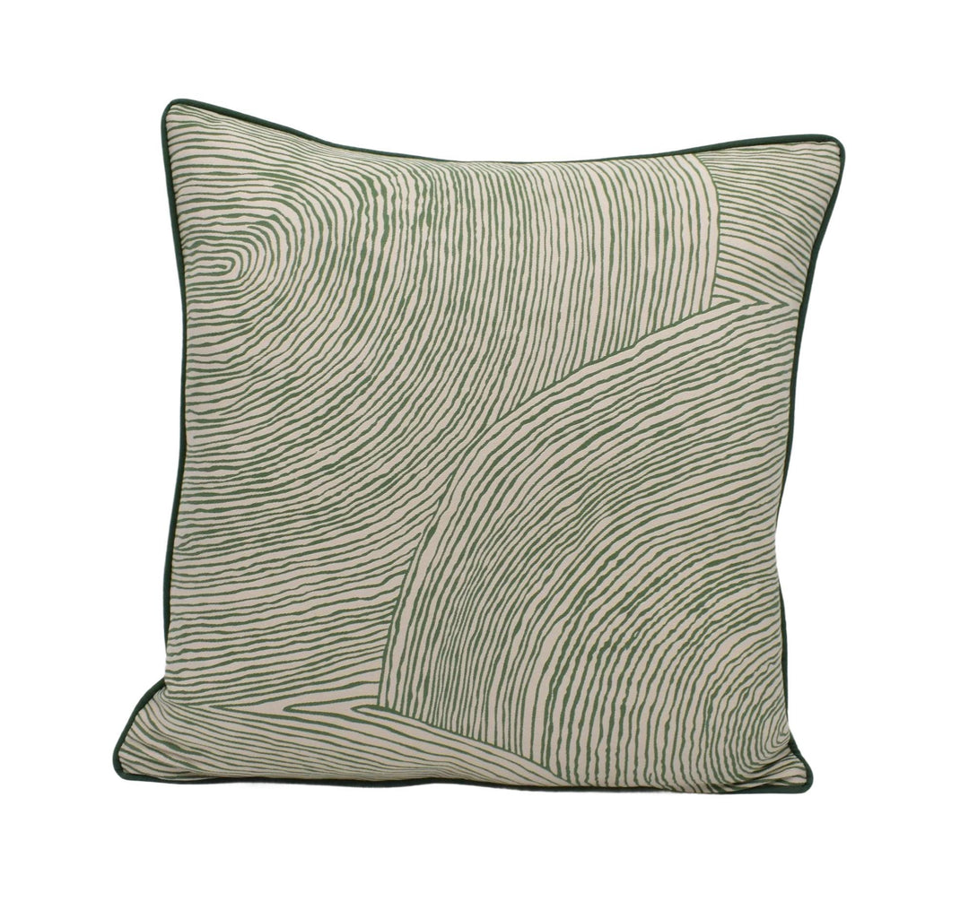 a green and white pillow on a white background