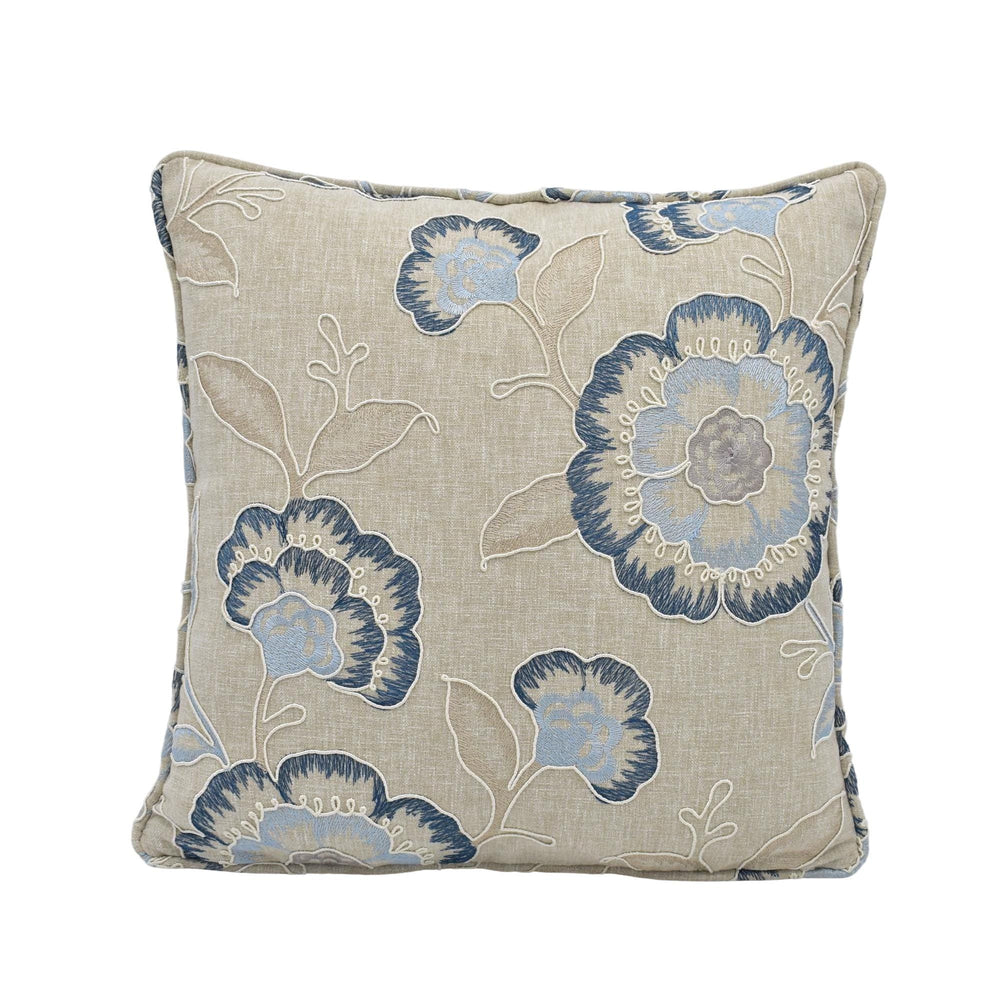 a square throw pillow with a floral print in shades of blue and beige.