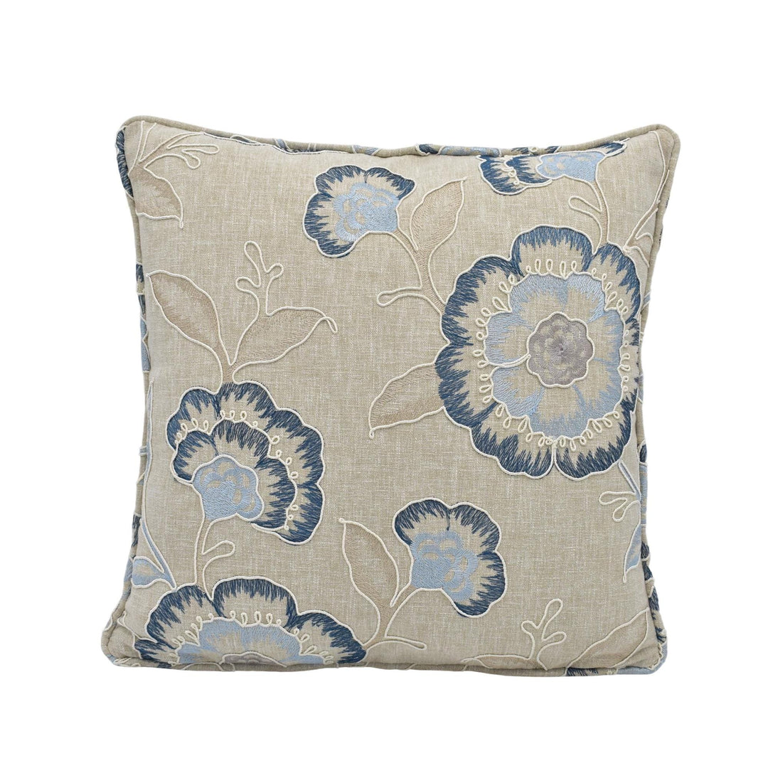 a square throw pillow with a floral print in shades of blue and beige.