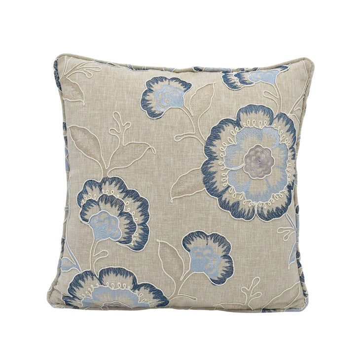 a square throw pillow with a floral print in shades of blue and beige.