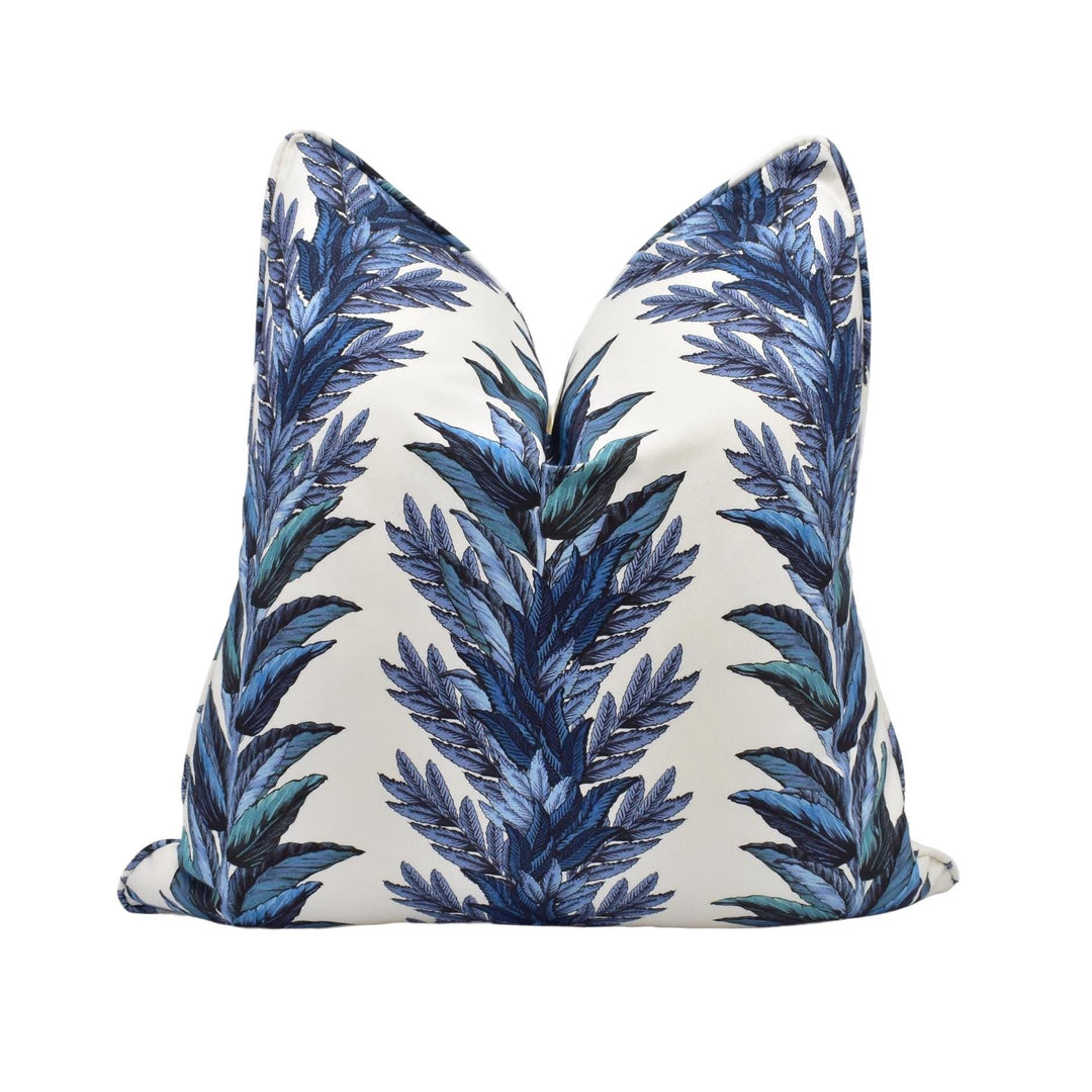a blue and white pillow on a white background
