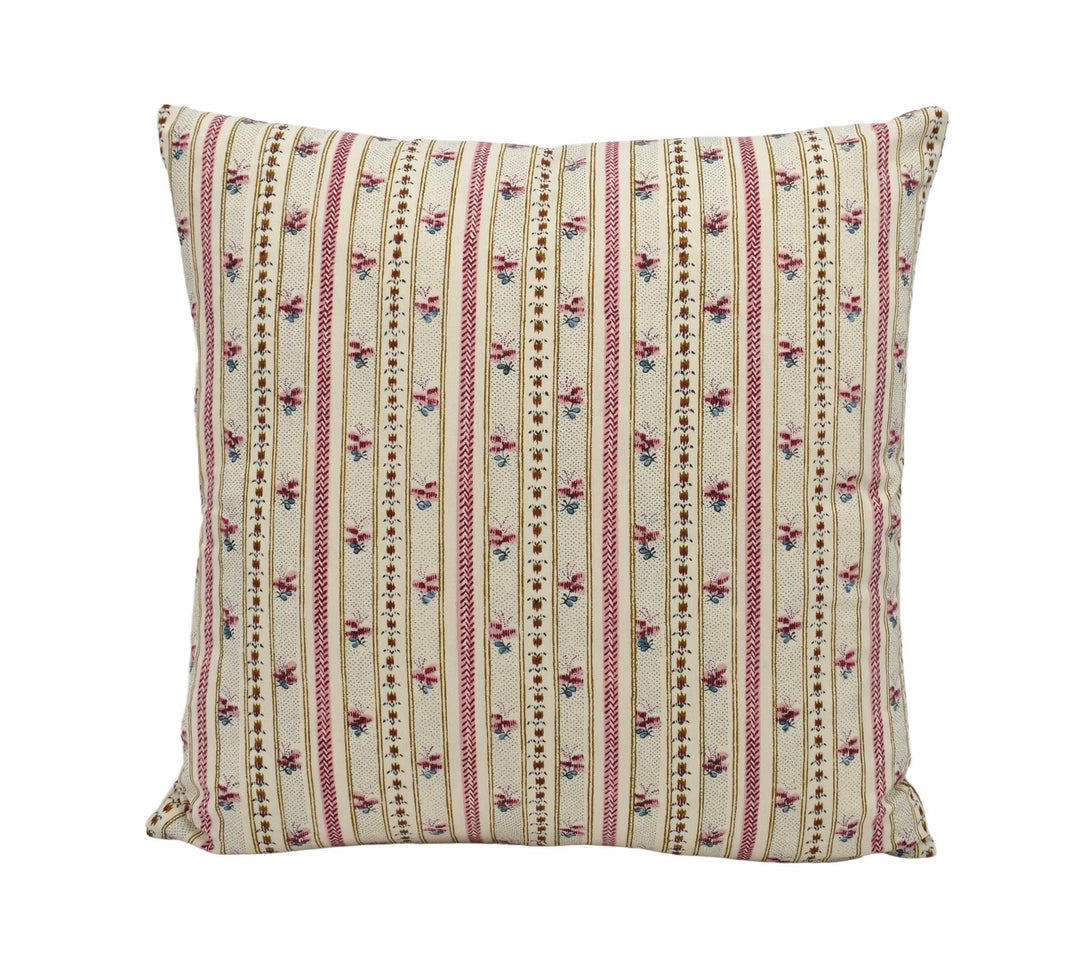 A square throw pillow with a floral pattern in shades of pink and beige.