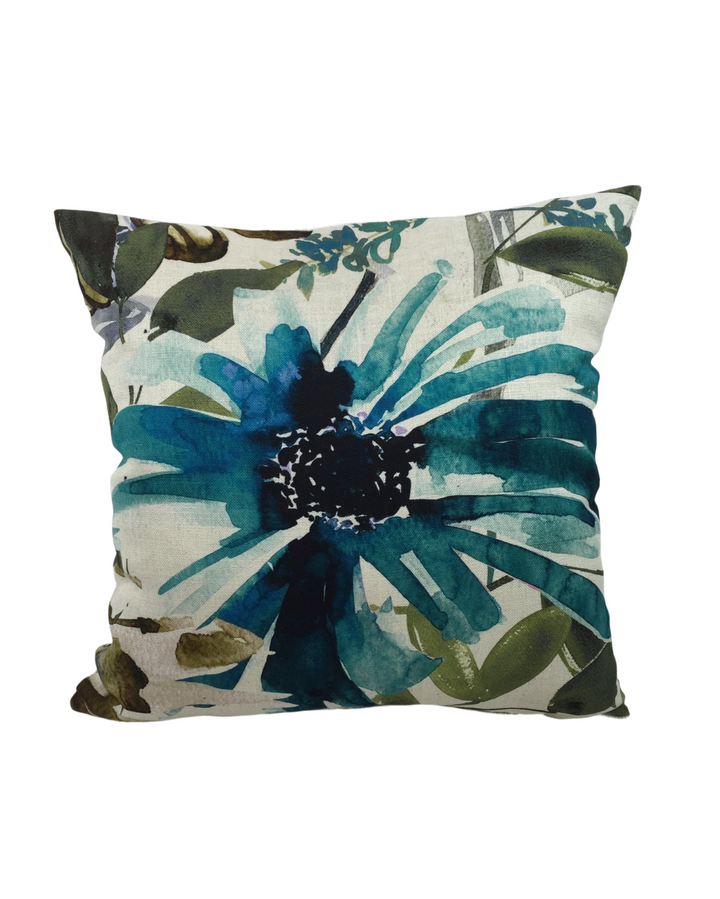 a pillow with a blue flower on it