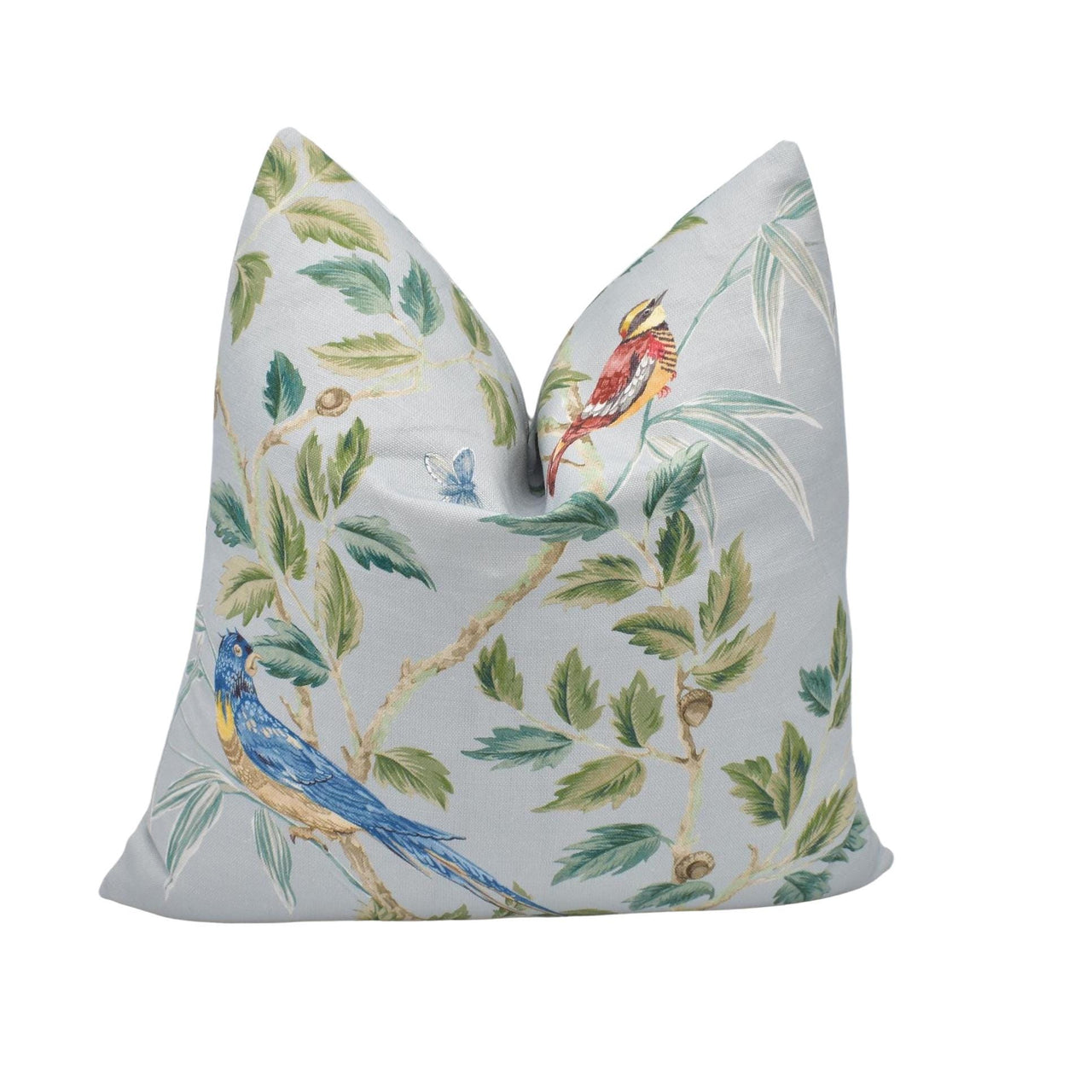 a white pillow with a blue bird on it