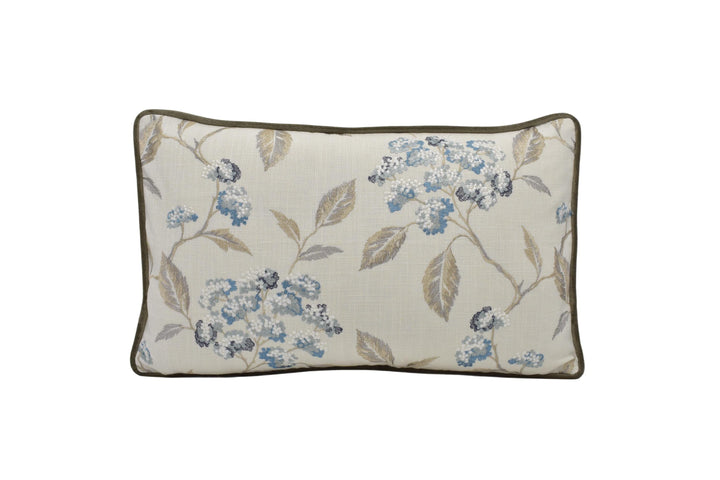 a white pillow with blue flowers on it