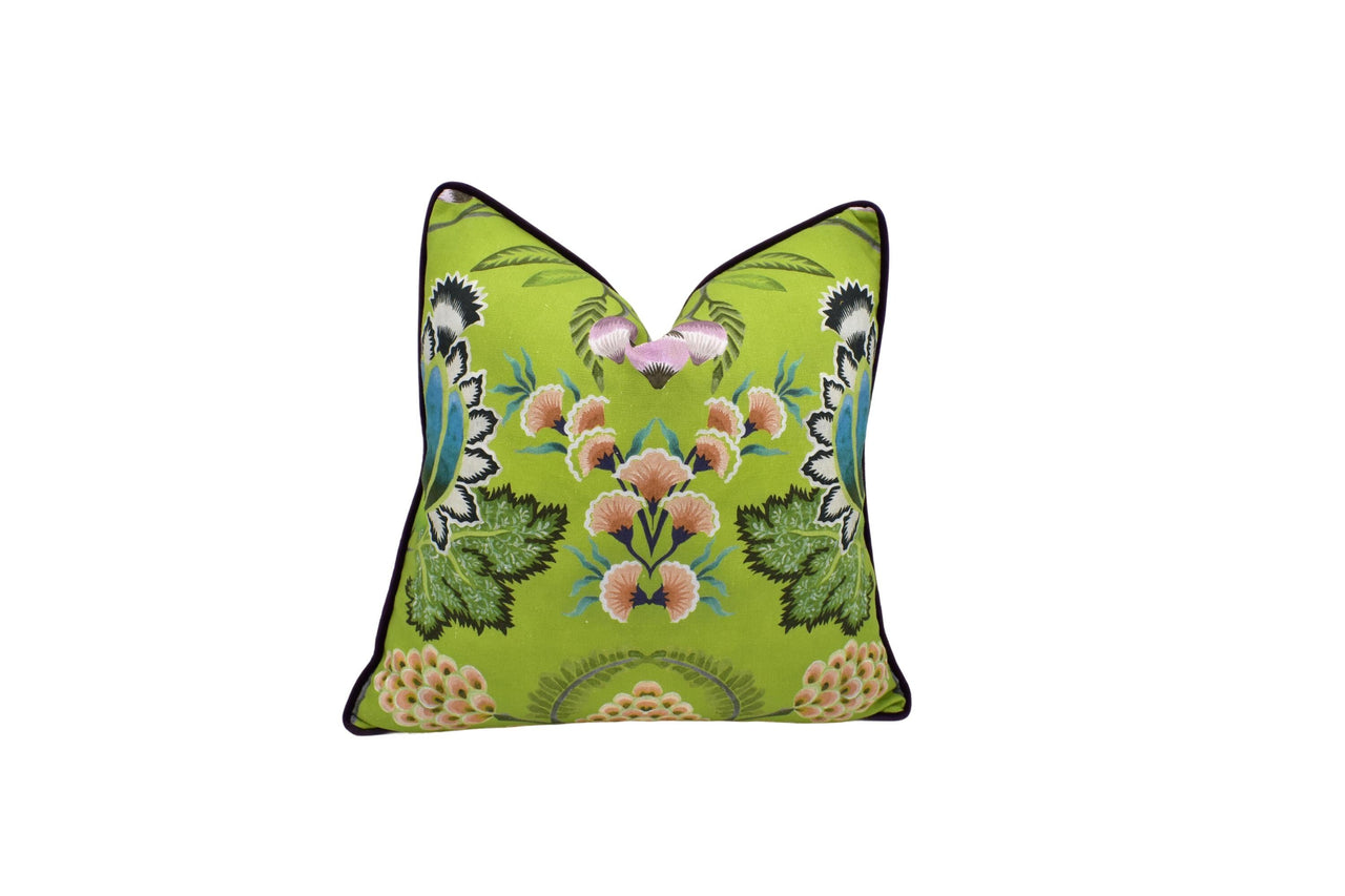 a green pillow with pink flowers on it