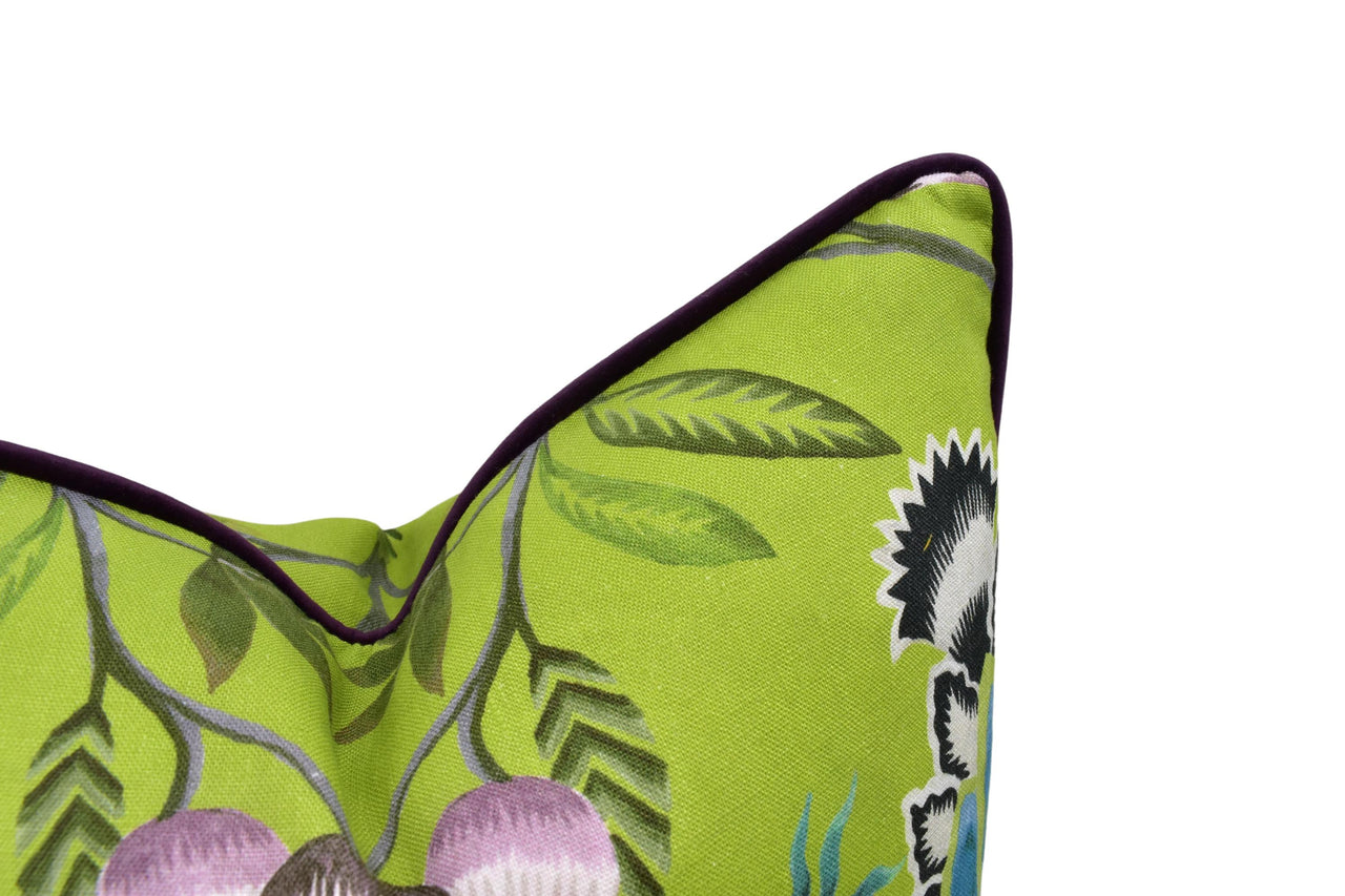 a close up of a green pillow with flowers on it