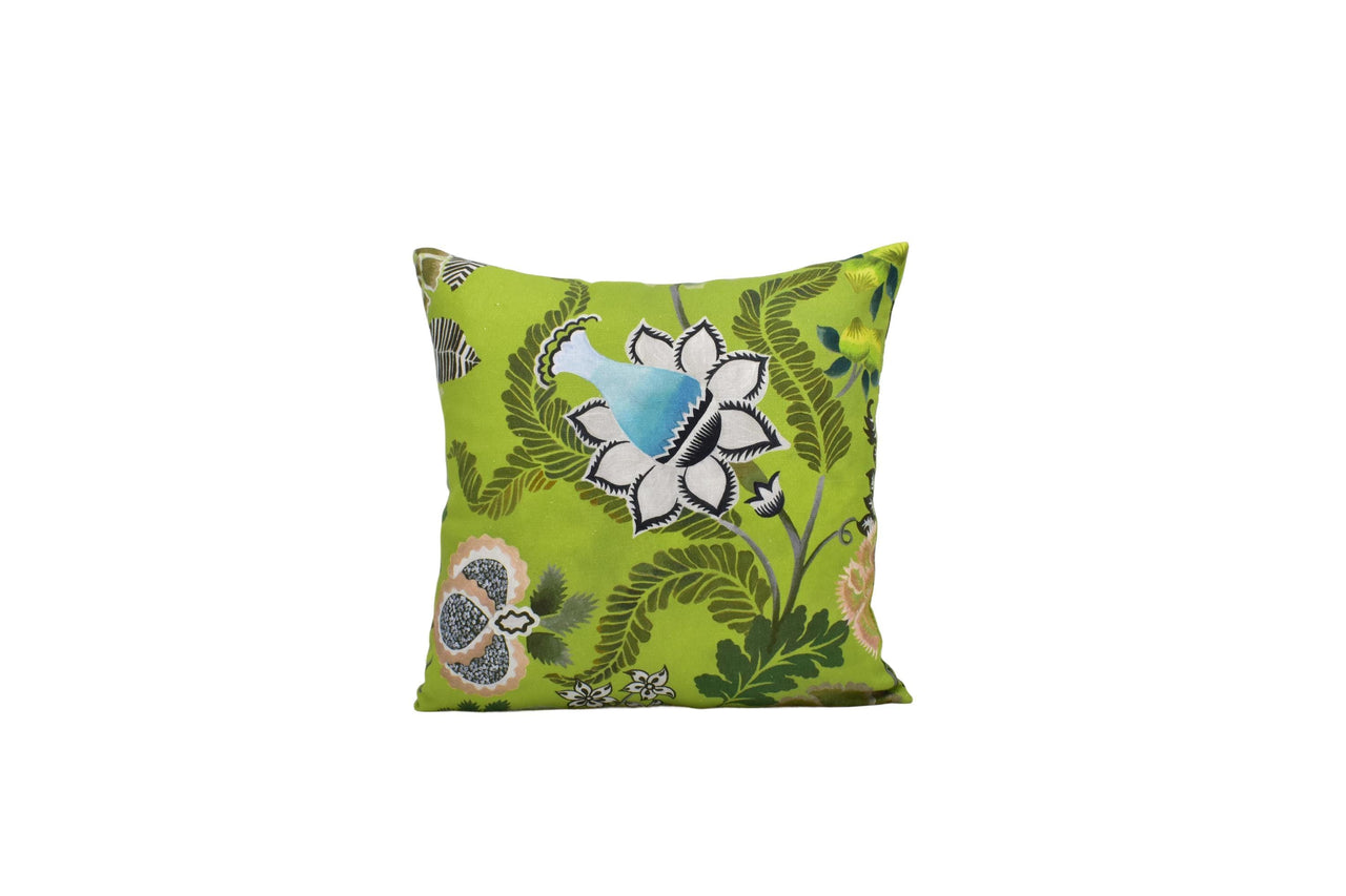 a green pillow with a blue flower on it