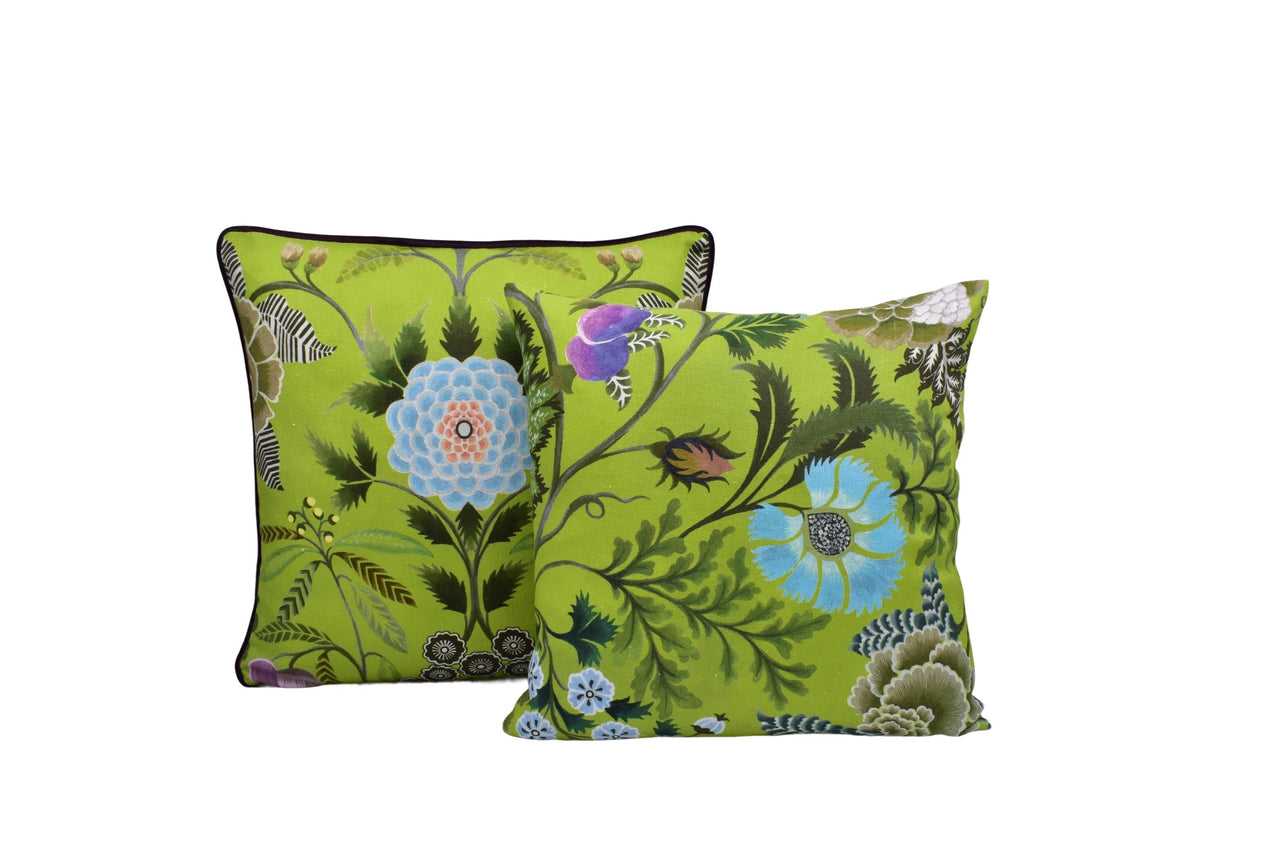 a pair of green floral pillows on a white background