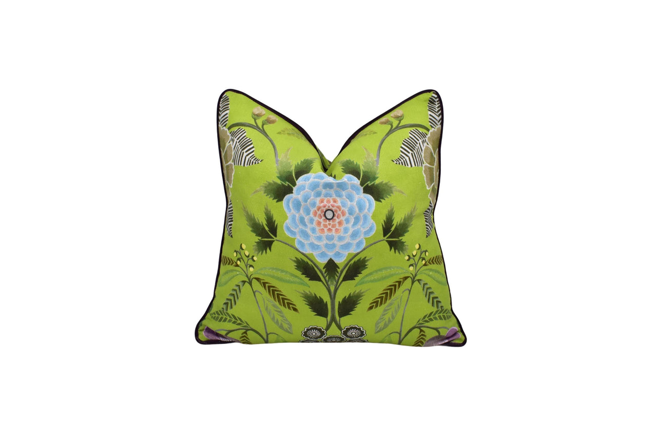 a green pillow with a blue flower on it