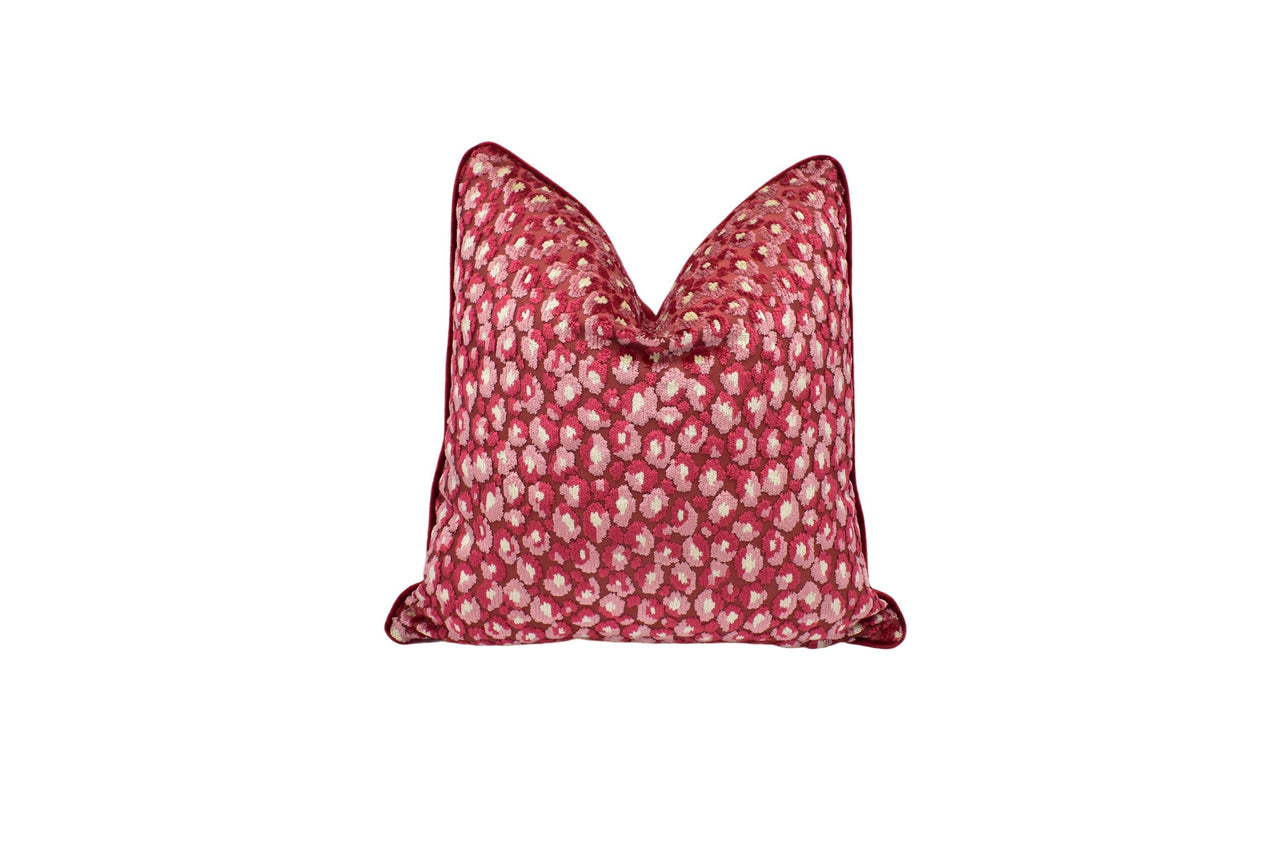 a red and white pillow with a bow on it