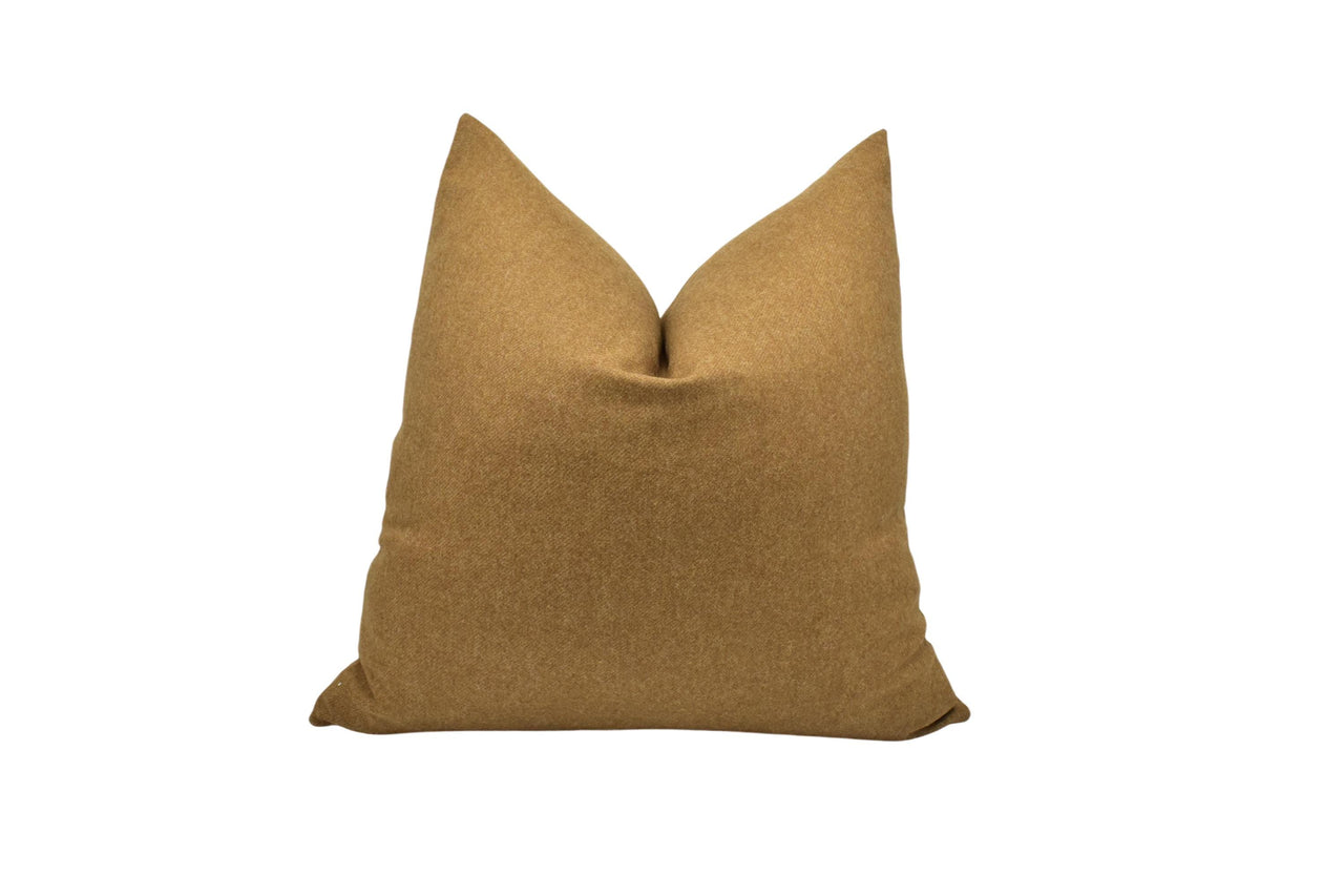 a brown pillow on a white background